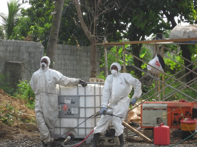 workers in protective clothing doing work on a building site