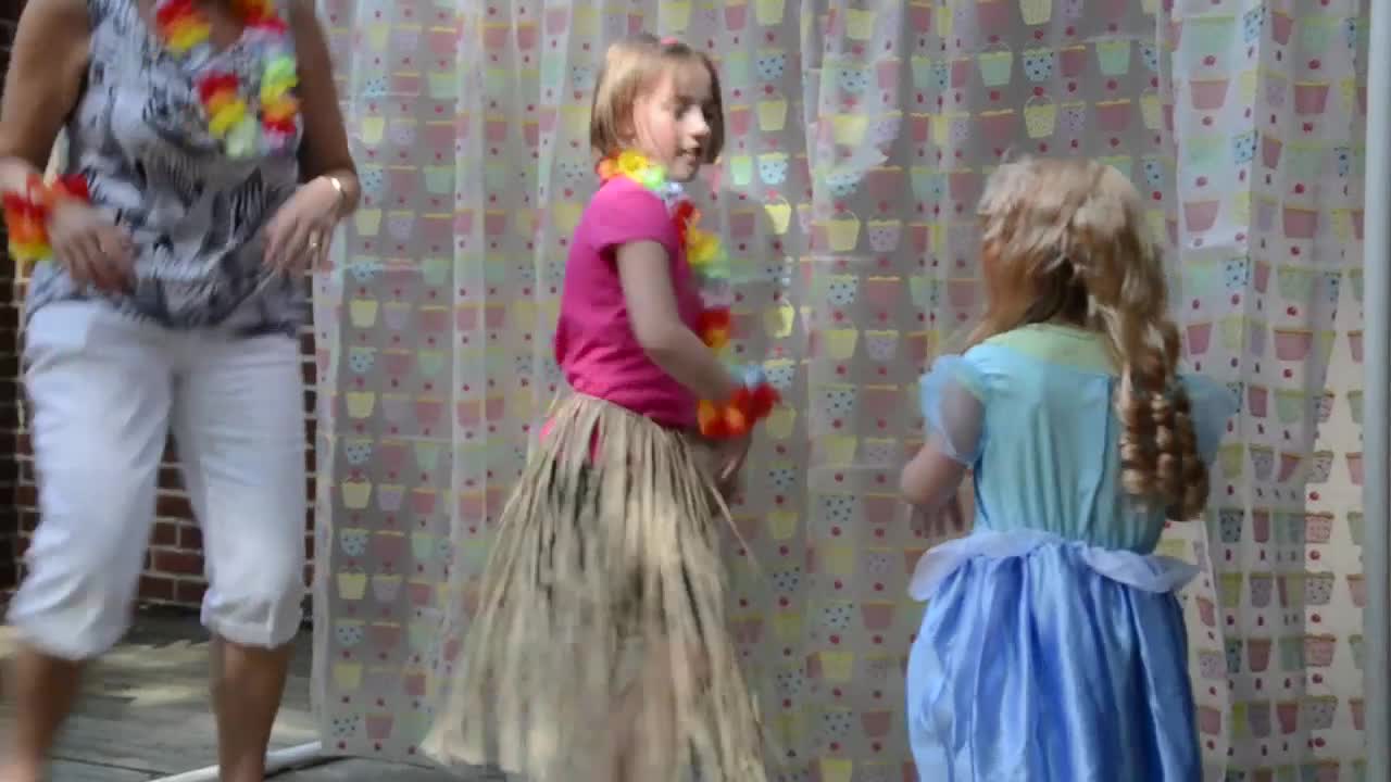 little girls are playing with soap bubbles on a shower curtain