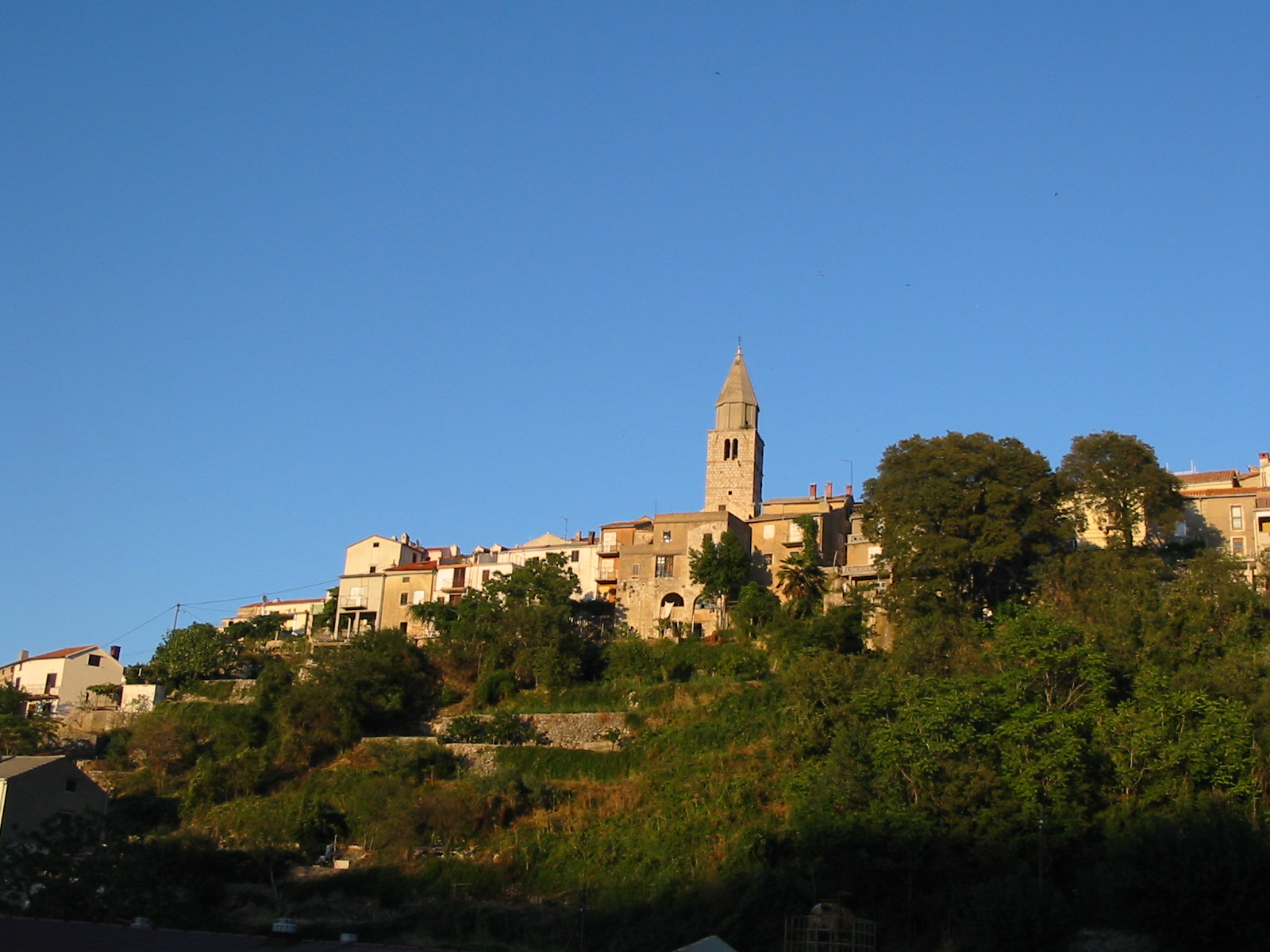 a hillside view with buildings on a hill