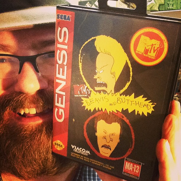 a man holding up a box with the cover of a video game