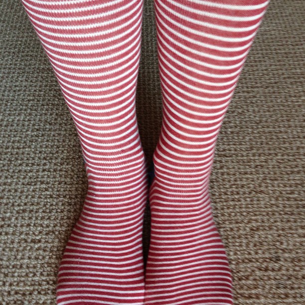 a pair of women's red striped stockings are seen