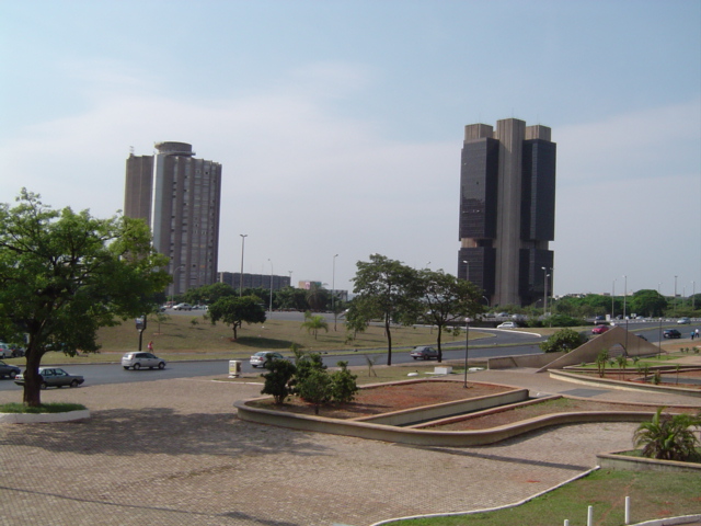 a square in front of some buildings and traffic