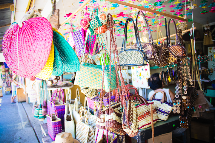 colorful handbags for sale hanging in a store
