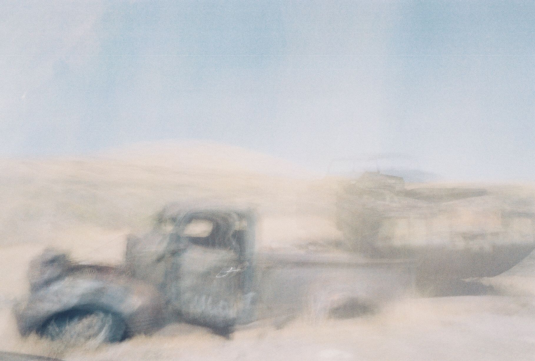 a blurry po of a dump truck in the desert