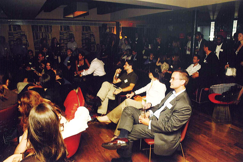 a group of people sitting around in chairs