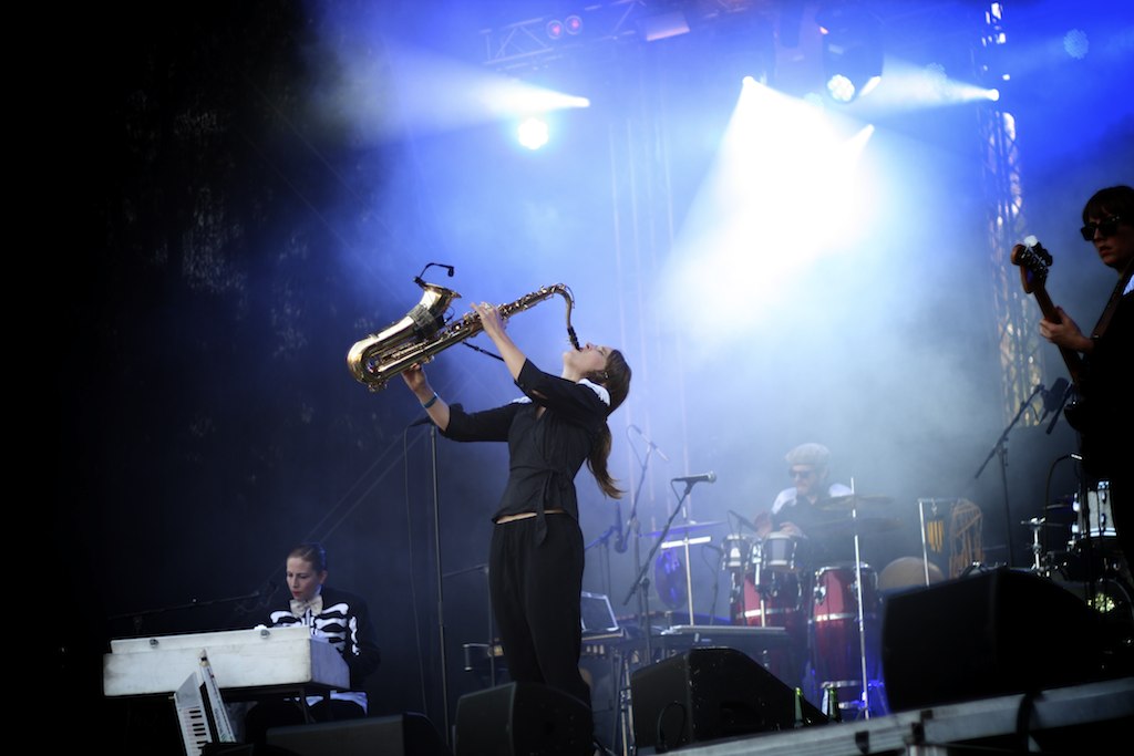 a man playing a saxophone while on stage