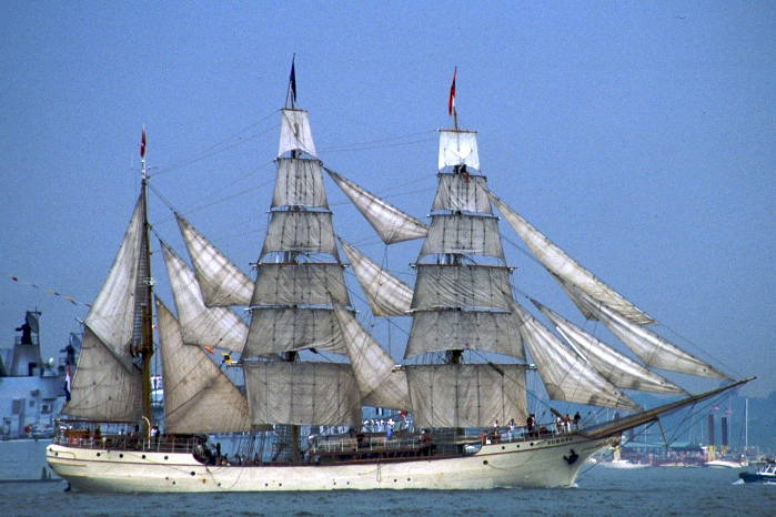 a very tall sail ship on the water