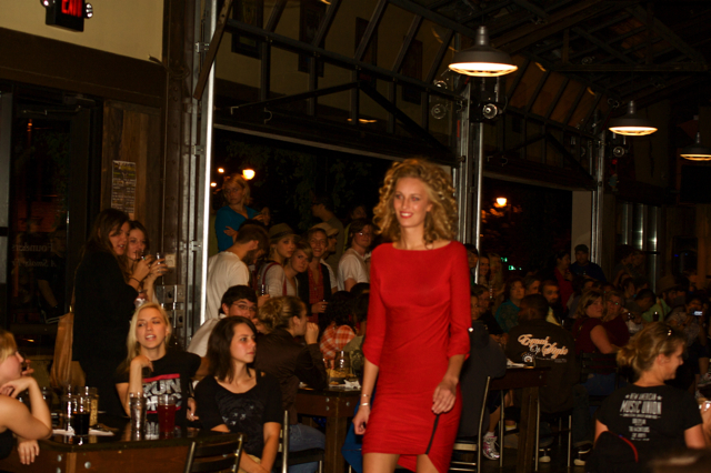 an all red outfit for a woman and people in a crowded restaurant