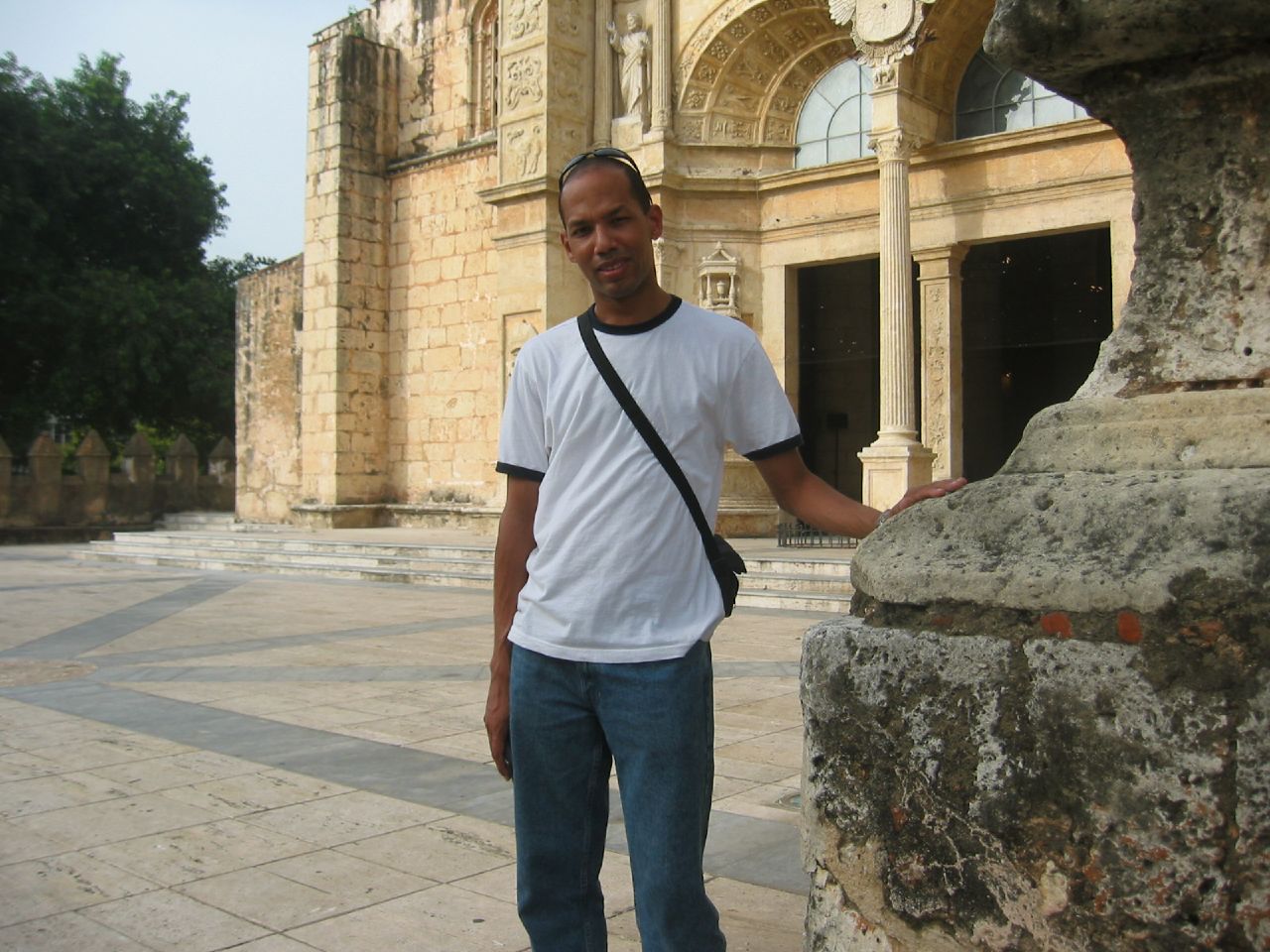 man standing in front of old, historical building posing for the camera