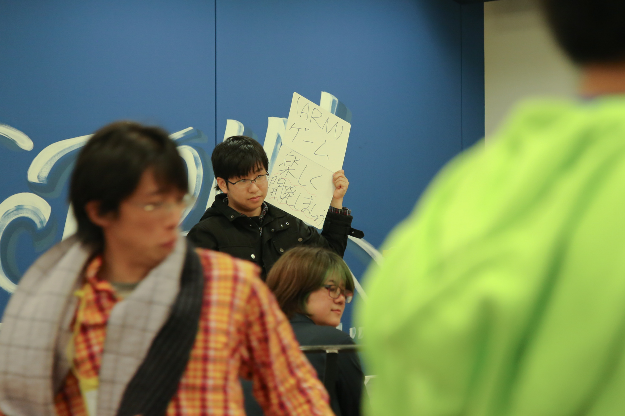 people gathered at an office with signs about computers