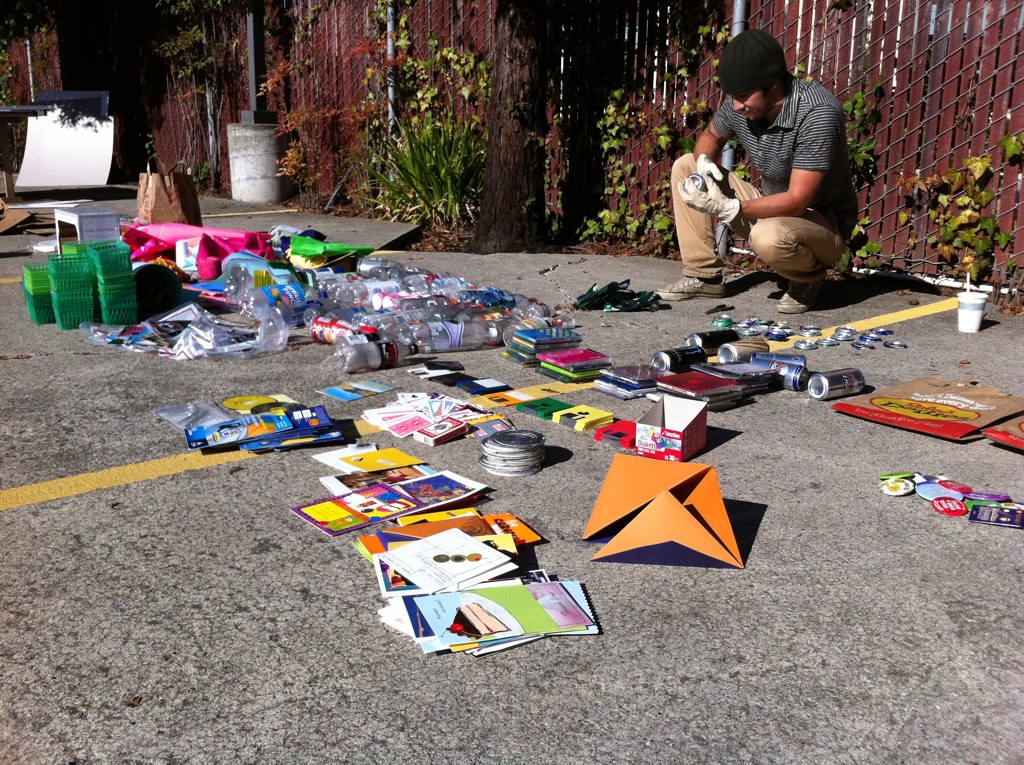 someone sits on the ground assorted art and crafts