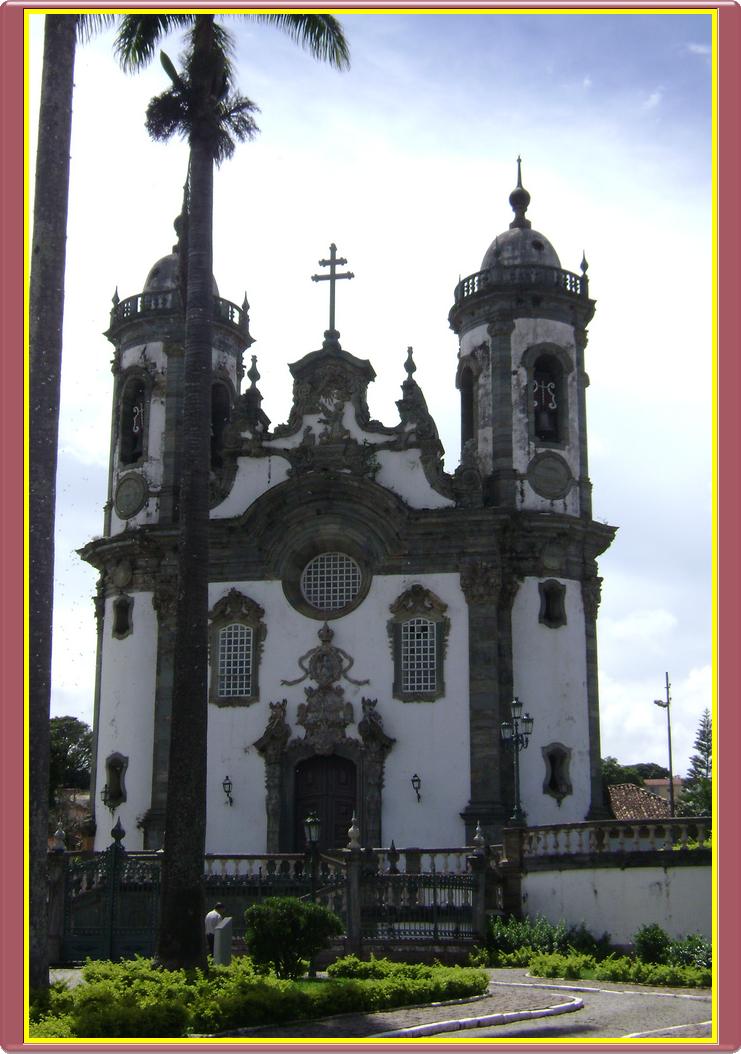 large gothic style building in white with black accents and red trim