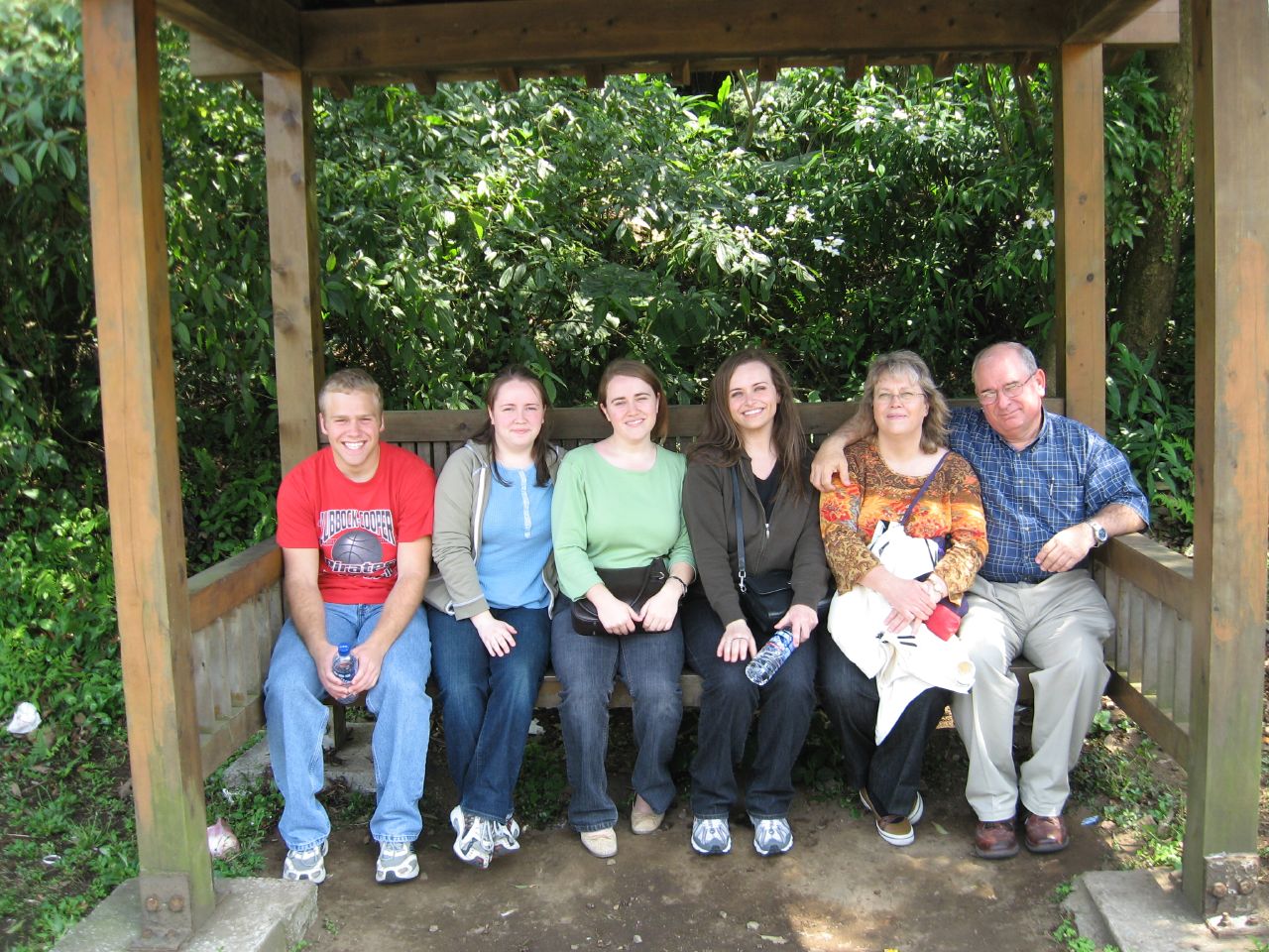 a group of people are sitting on a bench