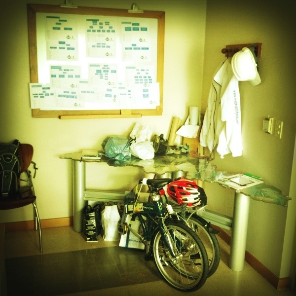 a motor bike is parked near a wall with a sports chart