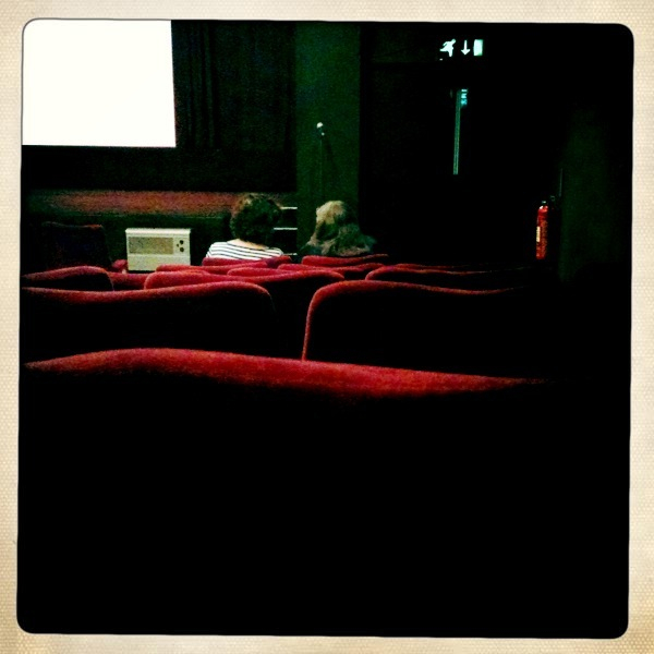 an auditorium with two men sitting in the seats