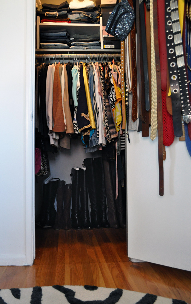 a closet with many clothes and boots on the shelves
