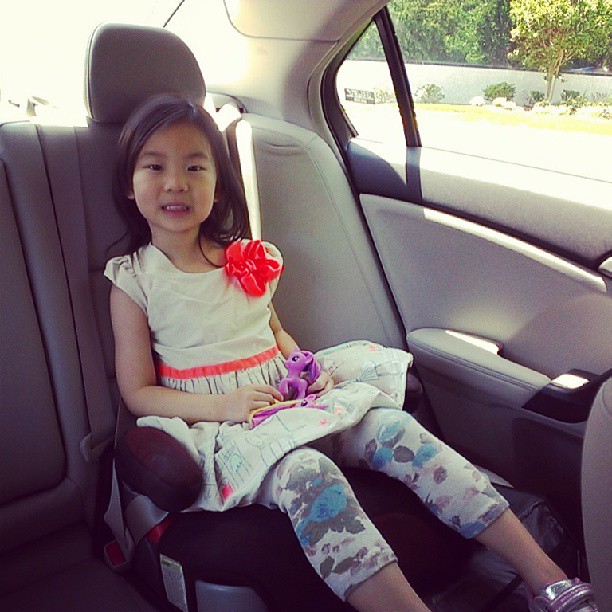 a little girl sitting in her car seat