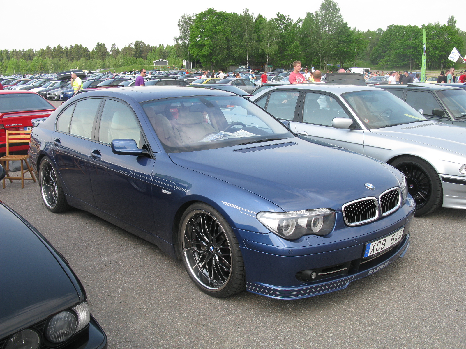 several bmw cars parked next to each other in a parking lot