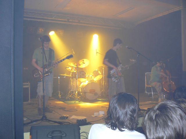 the band is performing on stage in the dark