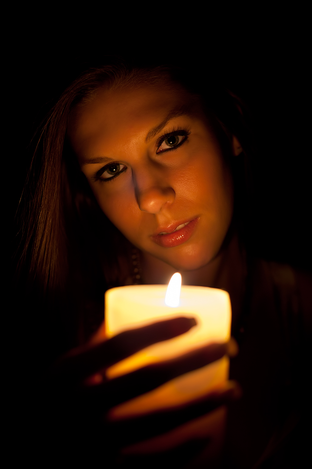 the woman is holding a candle that has not been lit