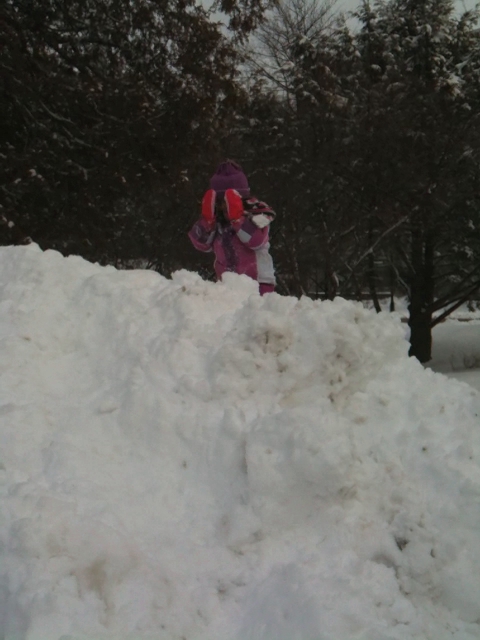 a person standing on a pile of snow