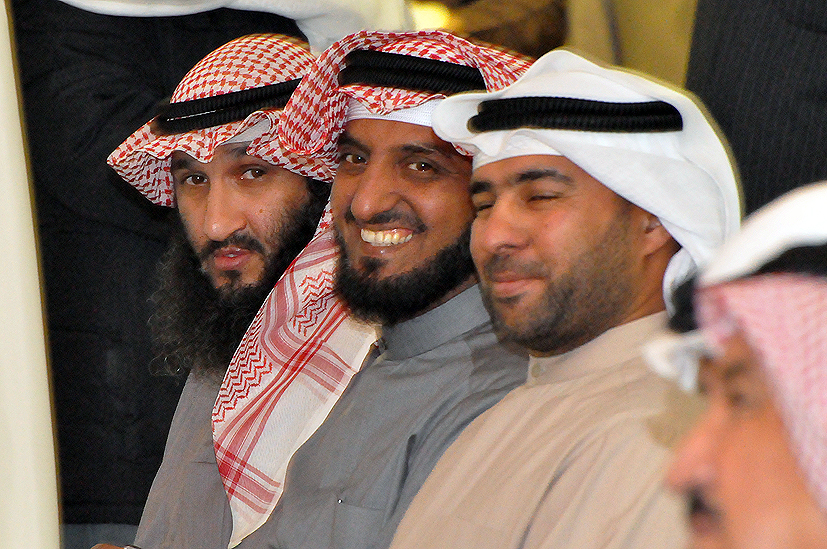 several people with headscarves sit together at a ceremony