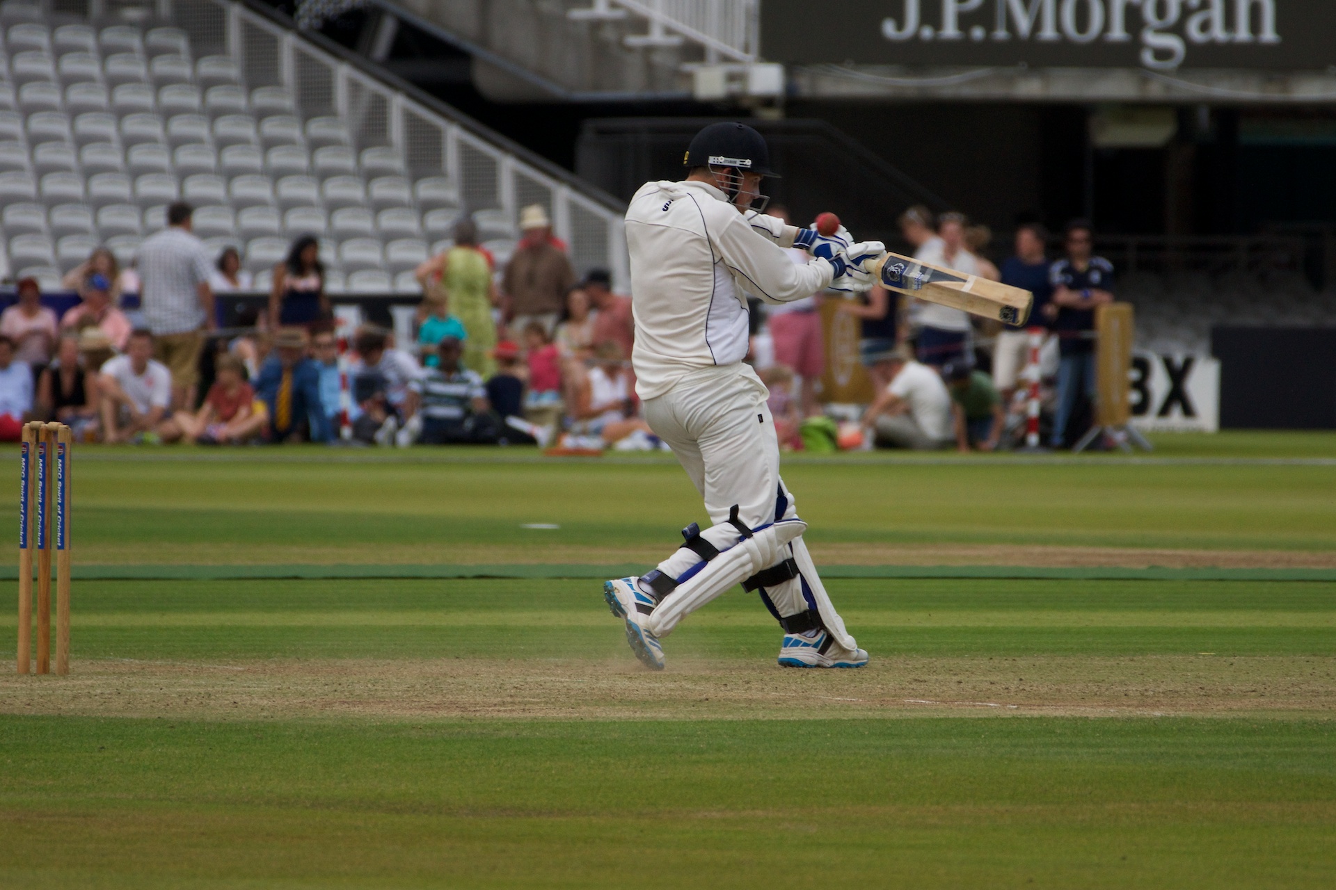 there is a man playing a game of cricket