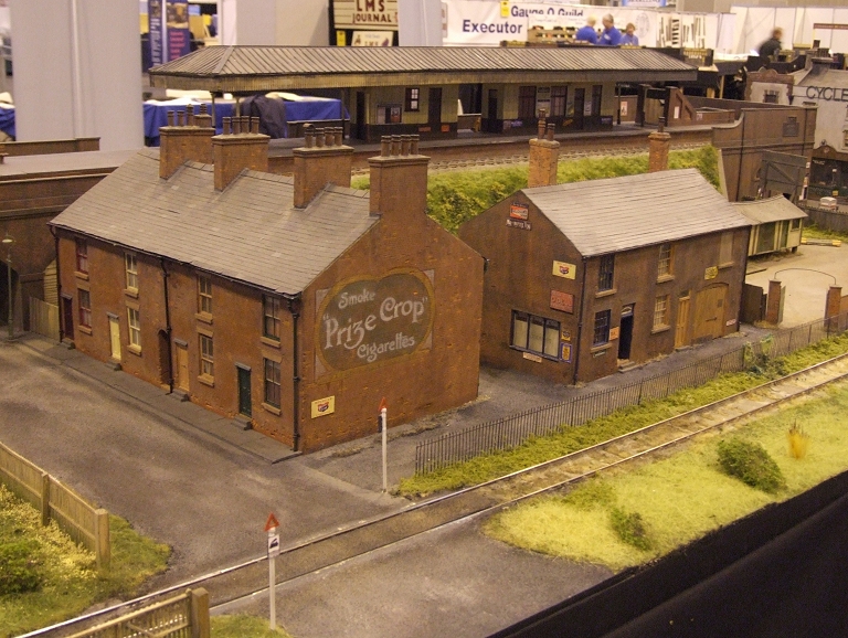 a model train station and some buildings on the track