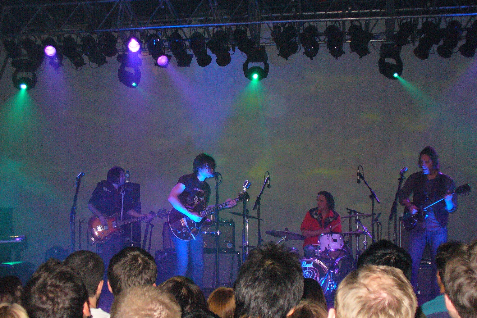 group of people with instruments standing on stage