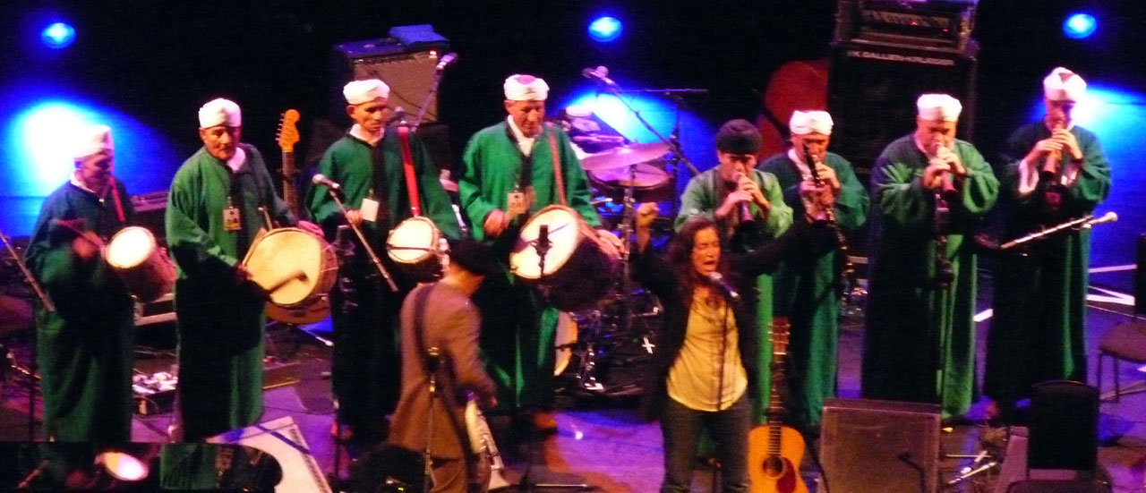 the men in green are playing instruments at night