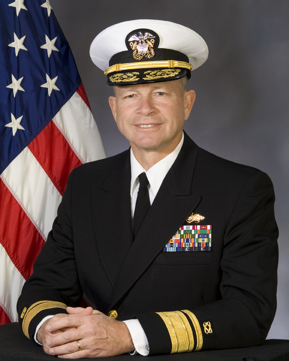 an american naval officer is posing with his arms crossed