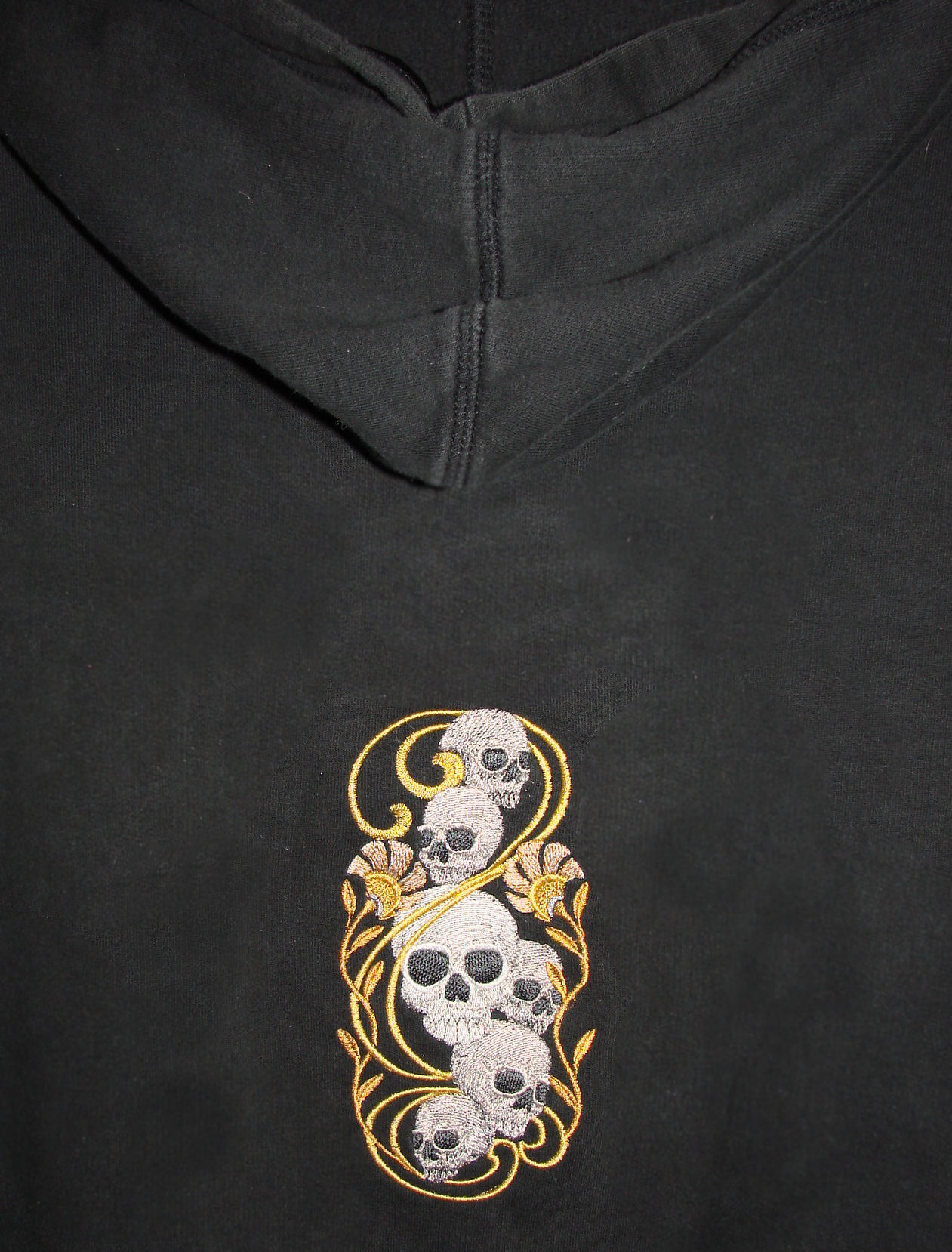 a black hooded sweatshirt with a skull and crossbone design