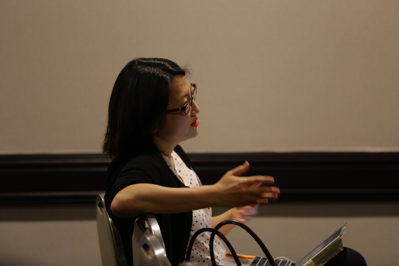 a person sitting in a chair with a laptop computer