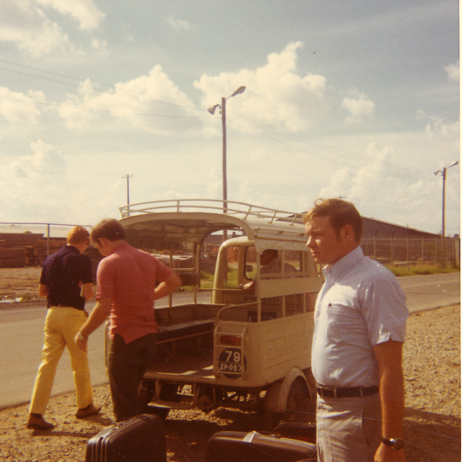 men standing near an old van that is parked