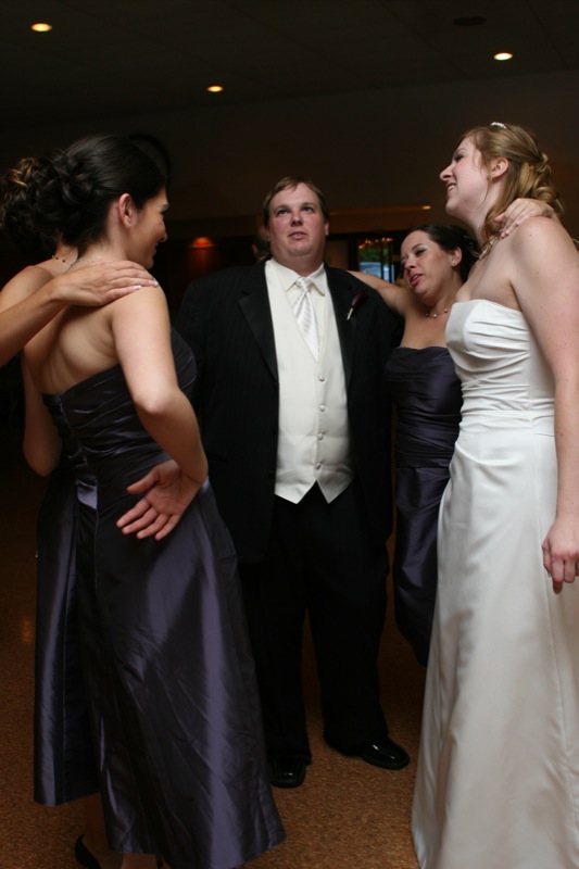the groom is standing next to a beautiful woman and two other people