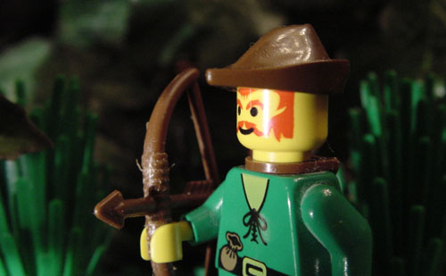 a lego man with a bow and arrows in his hand