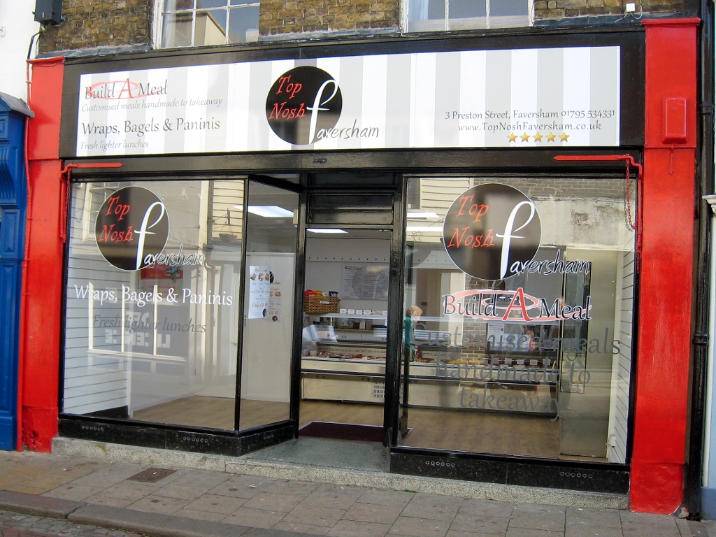 a large window is in front of a red building