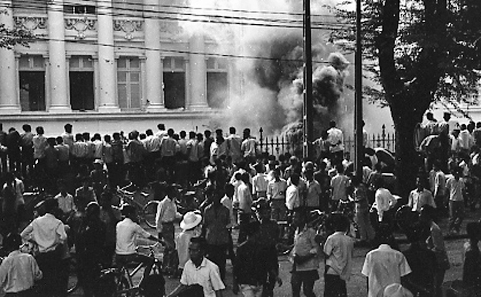 people on the street in front of a group of buildings