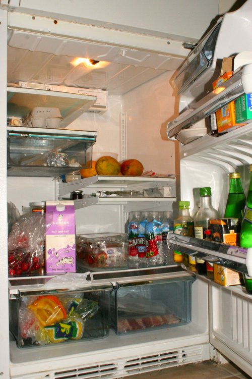 an open refrigerator with food inside of it