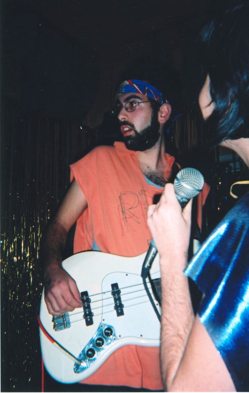 a man with a beard plays the guitar