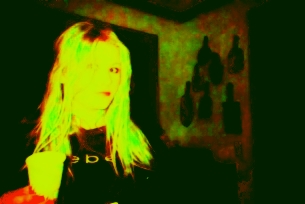 a person standing in the middle of a room with green and yellow lighting