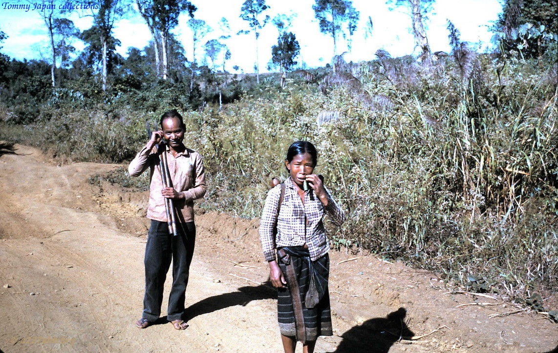 a woman and a child on a dirt road