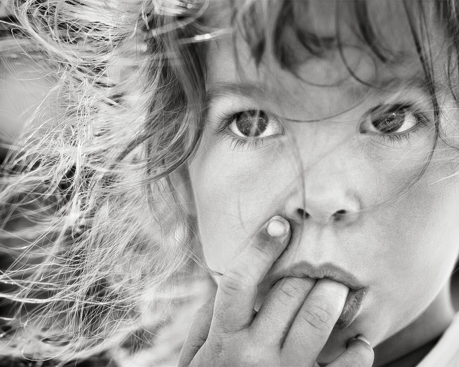 a close up of a person with her hand on her mouth