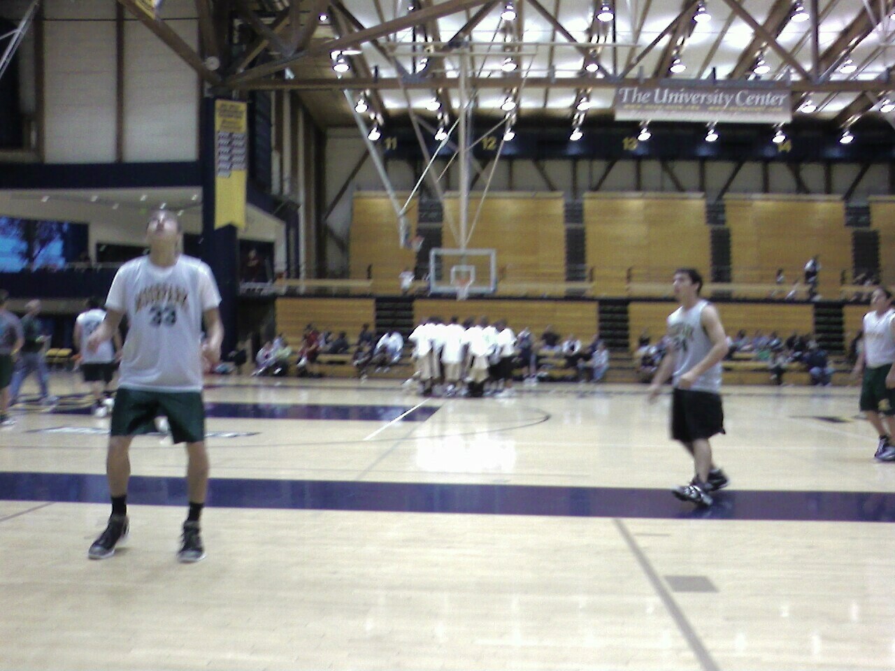 a group of people playing basketball inside a building