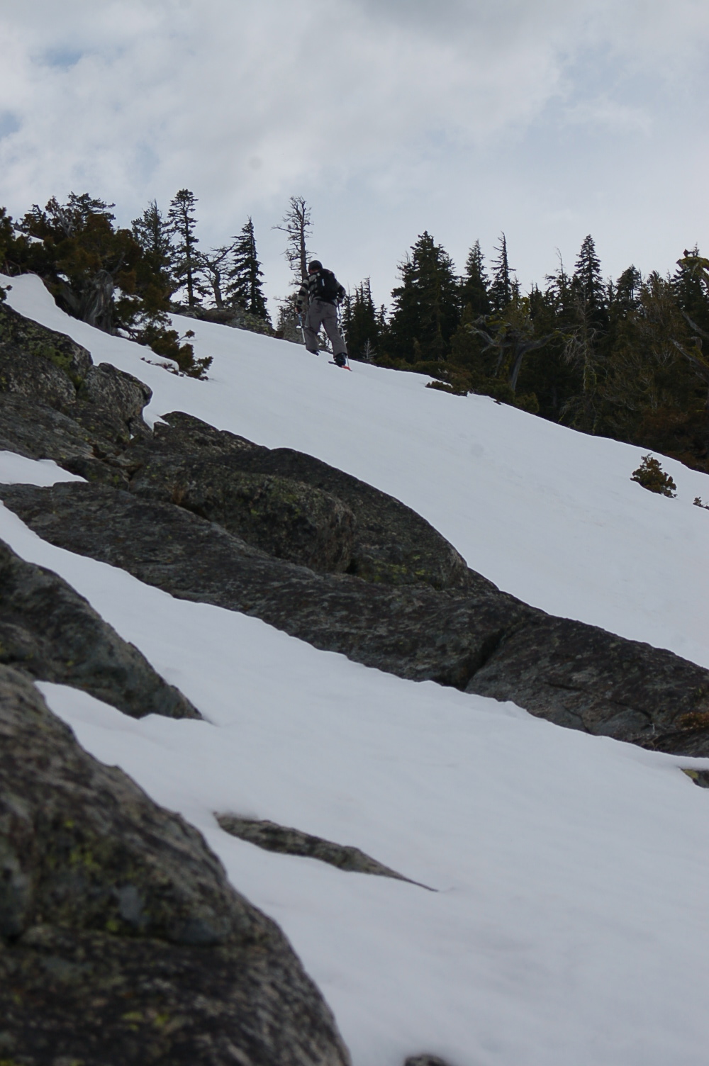 there is a snowboarder coming down the mountain on the snow