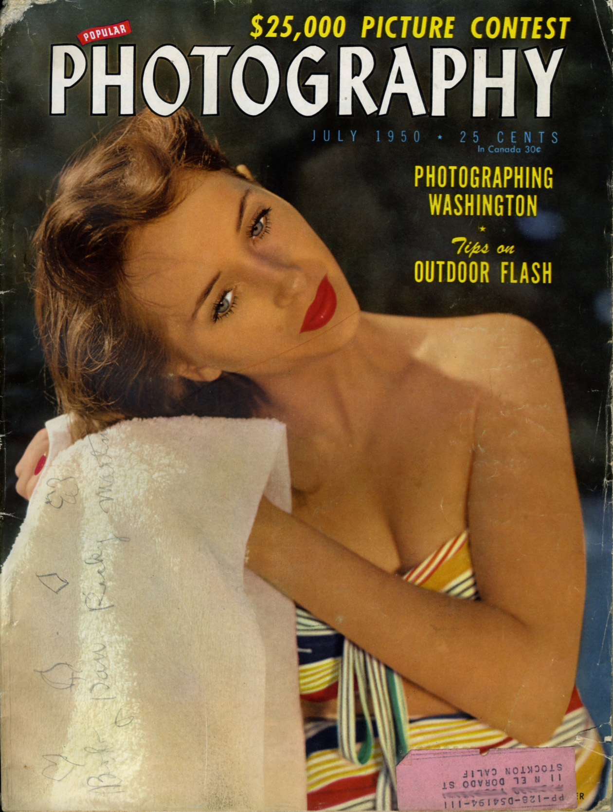 a woman wrapped in a towel while posing for a magazine