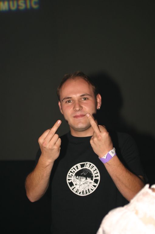 a man pointing to his finger and wearing a black shirt