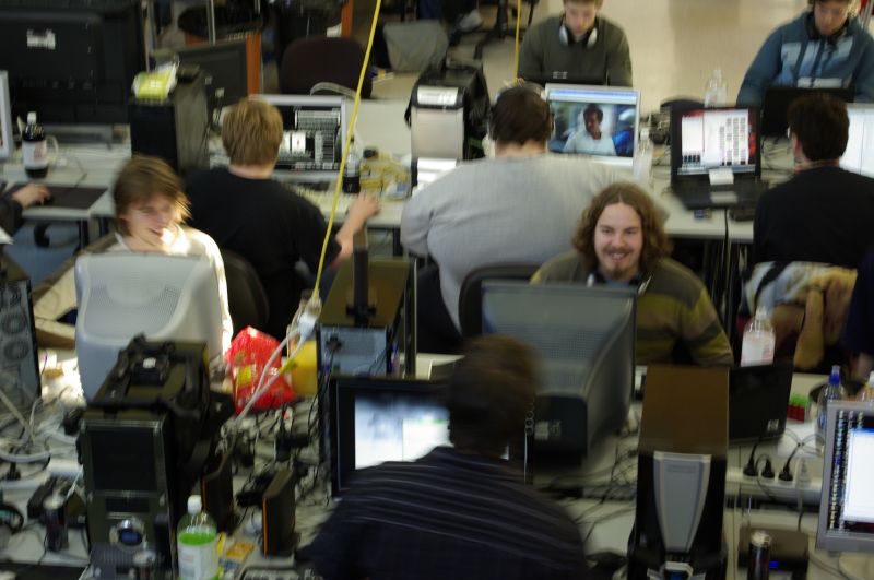 several people working on computers in an office