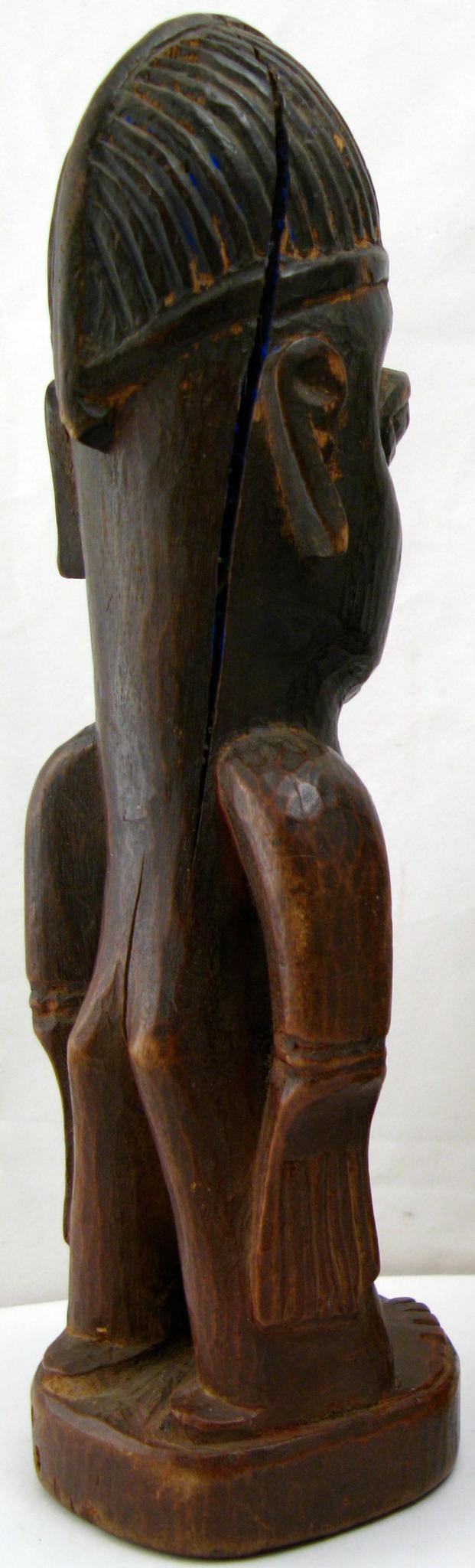 an old wooden sculpture of a man with a cap