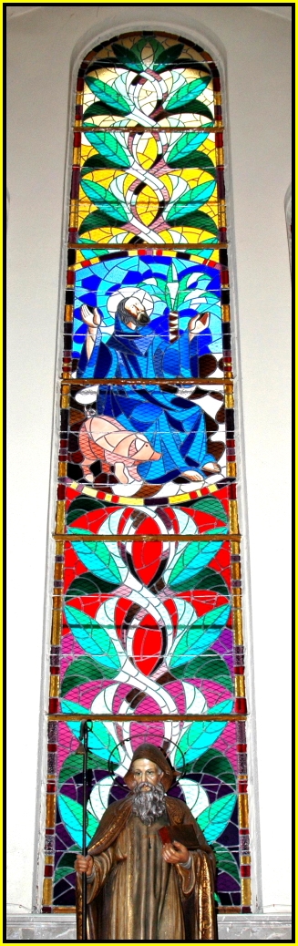 a stained glass window showing a man's image in red and blue